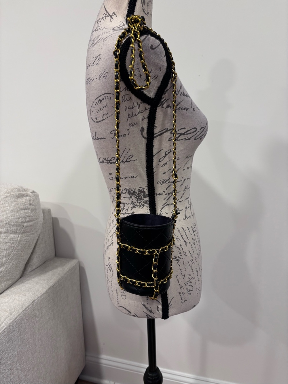 Black leather and gold colored chain water bottle holder